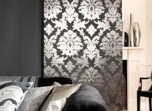 Detail of a black and silver damask sliding panel above cushions
